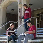 Photo of FSU students sitting on the steps of Bryan Hall