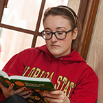 Photo of student reading textbook