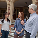 Photo of students in discussion with a professor