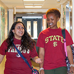 Photo of students walking through Residence Hall hallway