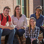 Photo of students sitting on steps on campus